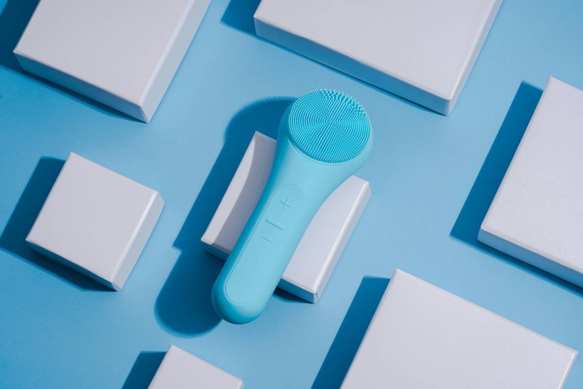 a blue and white electric toothbrush on a blue surface